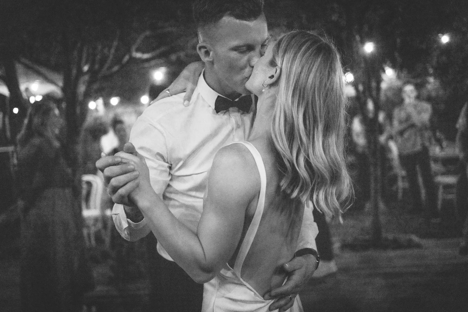 Black and white wedding couple kiss
