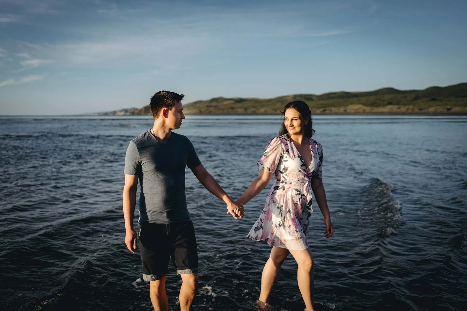 Raglan beach engagement couple in water