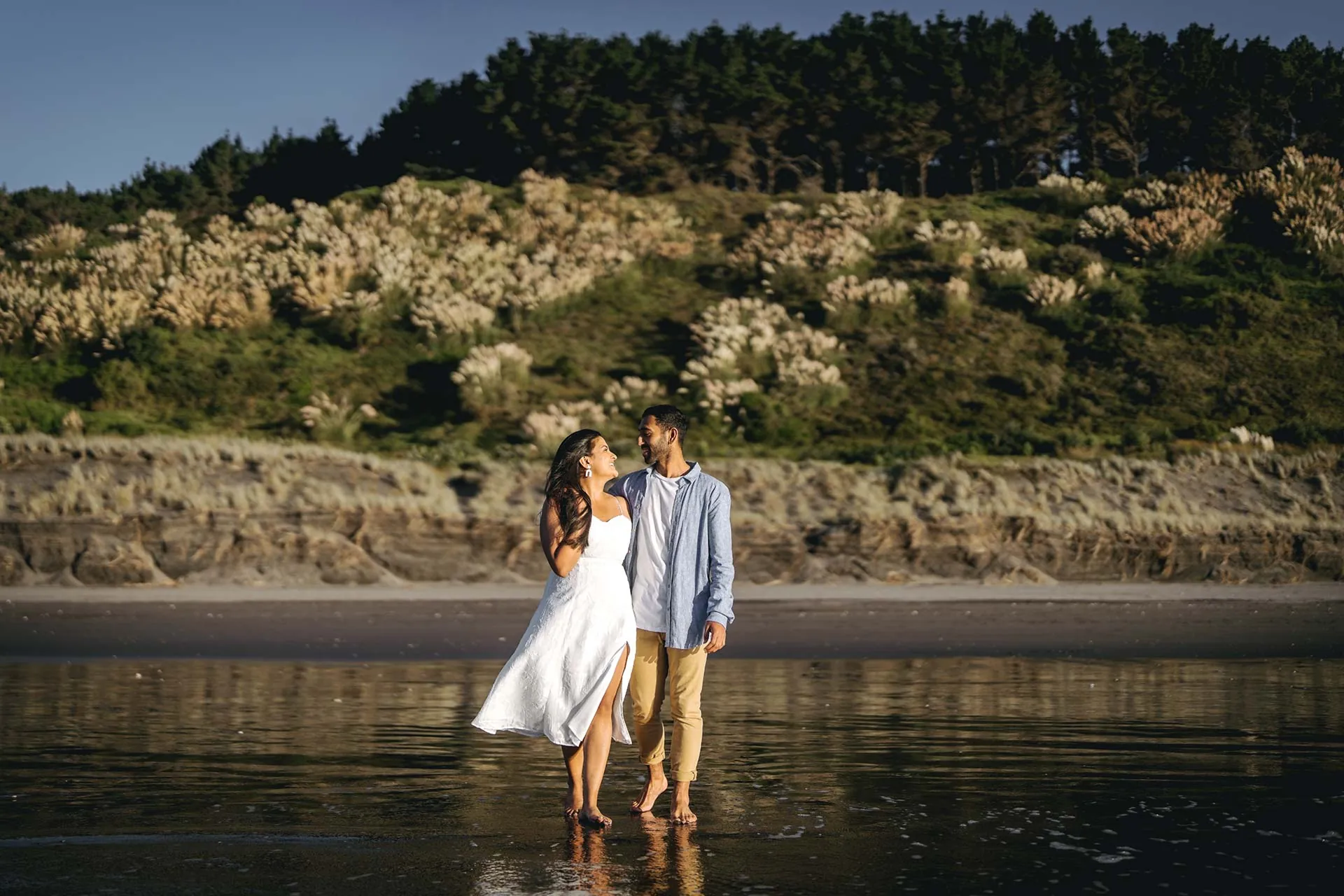 Raglan beach engagement couple reflection