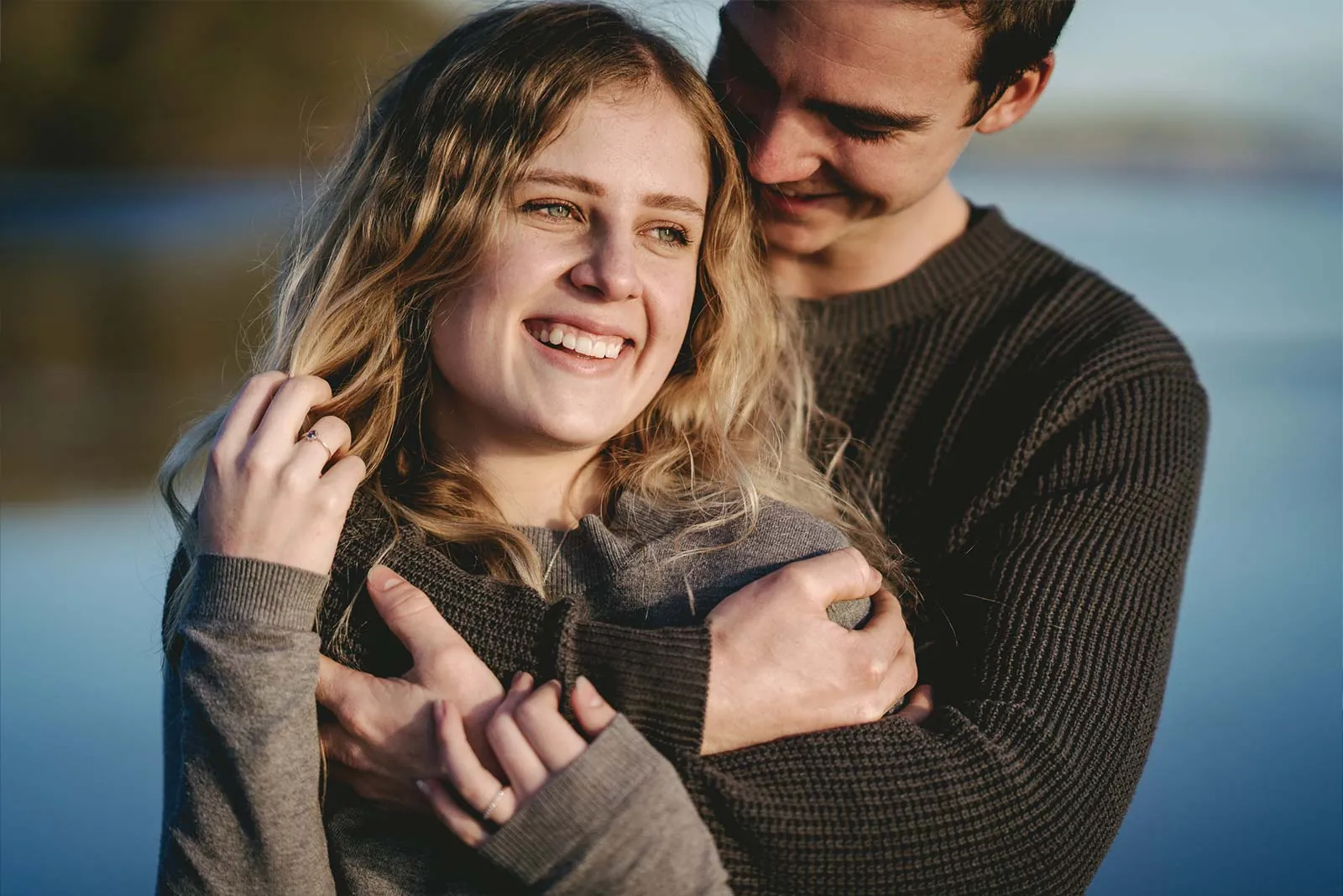 Candid lakeside engagement portrait