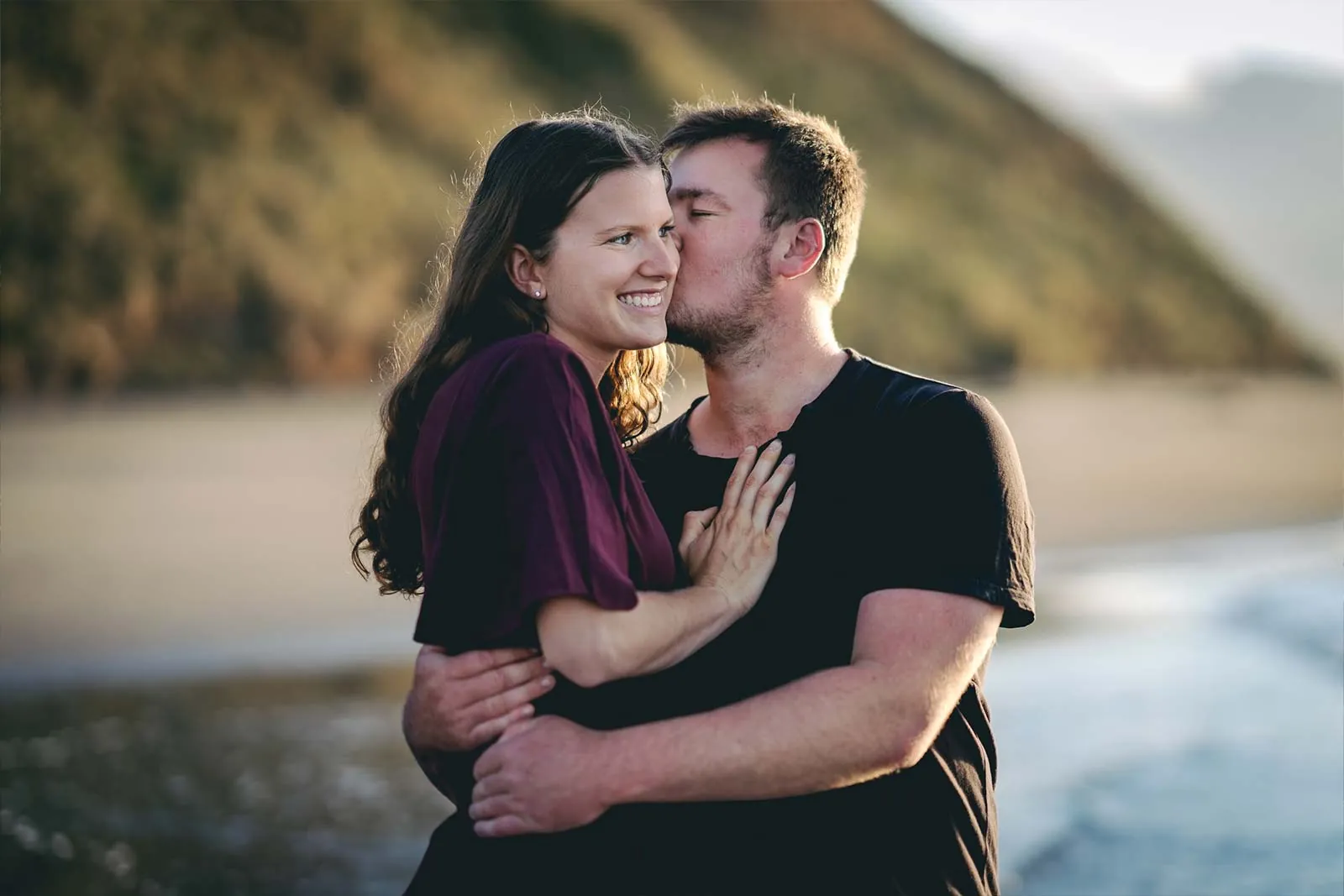 Romantic couple portrait on a Raglan beach