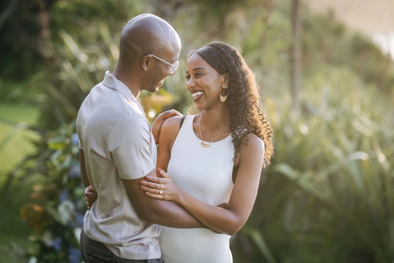 Engaged couple sharing a sunset garden moment