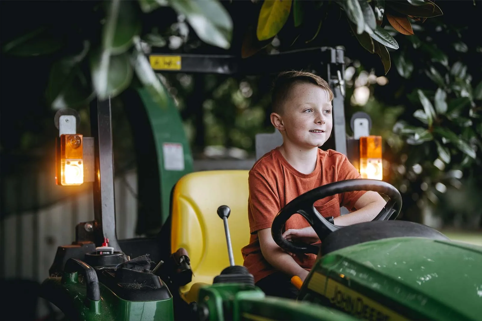 Child enjoying a family farm tractor