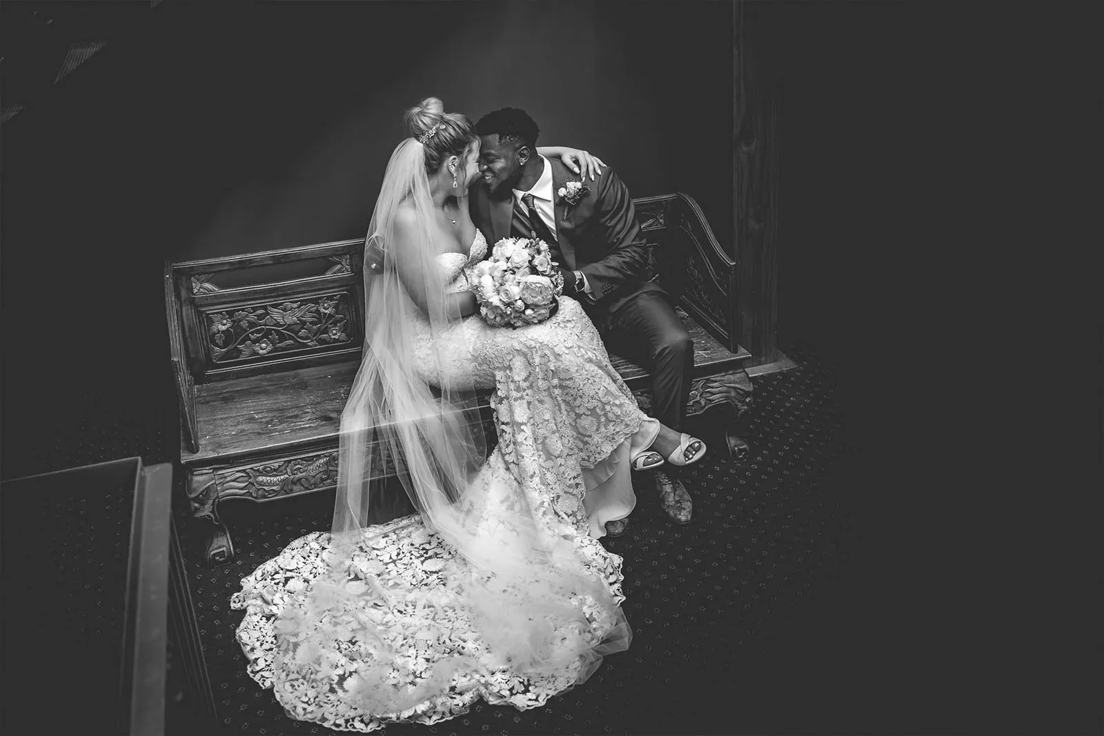 Black and white bride and groom portrait in a vintage room